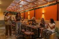 un grupo de mujeres sentadas en una mesa en un restaurante en The Hosteller Goa, Candolim, en Candolim