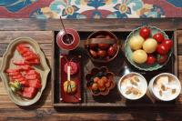 a group of bowls of fruits and vegetables on a table at DunHuang FengMingSha Hotel in Dunhuang