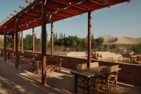 a group of tables and chairs under a pavilion at DunHuang FengMingSha Hotel in Dunhuang