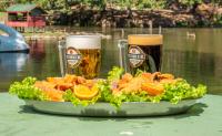 a plate of food with two beers and a salad at Parque Pousada Macaquinho Turismo in Serra Negra