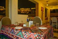 Una mesa en un restaurante con un mantel colorido. en Hotel Heaven In Jaisalmer, en Jaisalmer