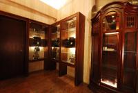 a room with wooden cabinets and glass shelves at Twinstar Hotel in Taichung