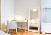 a bedroom with a mirror and a desk and a bed at Les Loges des Chalets in Toulouse