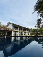 a resort with a pool in front of a building at Villa Nilnara in Ahungalla