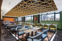 a dining room with tables and chairs and windows at 上海艾菲花园酒店The Garden F in Shanghai