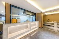 a lobby with a counter with a sink and a bar at GreenTree Eastern Beijing Happy Valley Wangsiying Shuanghe Subway Station Hotel in Beijing