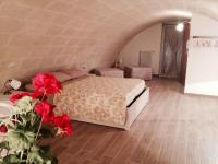 a bedroom with a bed and red flowers in a room at Le due arcate in Matera