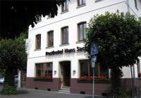 a white building with flowers in front of it at Posthotel Hans Sacks in Montabaur