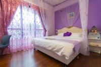 a pink bedroom with a bed and a window at Greek Wonderland B&amp;B in Hualien City