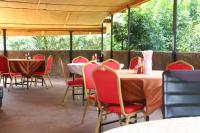 a group of tables and chairs in a restaurant at WELLSPRINGS HOTEl in Gulu