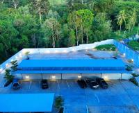 an overhead view of a parking lot with blue roofs at Happy Place Official in Nai Yang Beach