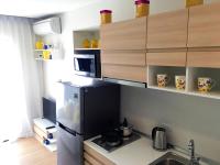 a small kitchen with a refrigerator and a microwave at Happy Place Official in Nai Yang Beach