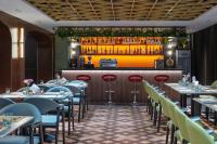 a restaurant with tables and chairs and a bar at 上海艾菲花园酒店The Garden F in Shanghai