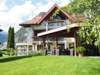 a large house with a lawn in front of it at Gästehaus Gerti in Nassereith