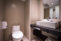 a bathroom with a white toilet and a sink at HOTEL HI- Chui-Yang in Chiayi City