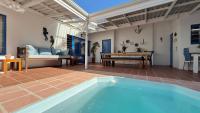 a house with a swimming pool in a patio with a table at BlueSky Arniston Guest House in Arniston