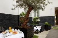 a table with food and drinks and a tree at Hotel Le Twelve in Paris