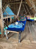 a cat sleeping on a blue bench in a room at Verani Beach Lodge in Makangale