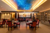 a restaurant with a dining room with a star ceiling at OCEAN PEARL in Bhīmunipatnam