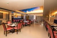a dining room with tables and chairs in a restaurant at OCEAN PEARL in Bhīmunipatnam