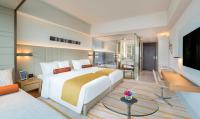 a bedroom with a large bed and a living room at The Prince Gallery Tokyo Kioicho, a Luxury Collection Hotel in Tokyo