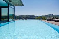 a swimming pool with a view of a building at Hotel Seegarten in Sundern