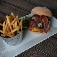 a sandwich and french fries on a white plate at The Lodge at Woodstone Country Club in Danielsville