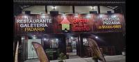 a restaurant with signs on the front of a building at Pousada Fruto do Mar in Saquarema