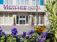 a building with purple flowers in front of it at Hotel Mercure Graz City in Graz