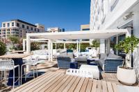 a patio with chairs and tables on a building at Golden Tulip Marseille Euromed in Marseille