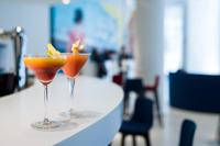 two cocktails sitting on top of a table at Golden Tulip Marseille Euromed in Marseille