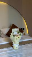 a bouquet of flowers in a vase on a bed at Essa camp in Wahiba Sands in Al Raka