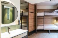 a bathroom with bunk beds and a mirror at LATROUPE Grand Place Hostel in Brussels