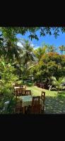 a group of tables and chairs in a park at Villa Claudia Nimal's kitchen in Ahangama