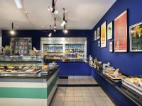 a bakery with blue walls and a counter with food at Greet hotel Darmstadt - an Accor hotel - in Darmstadt