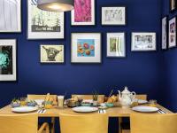a dining room with a blue wall and a table with chairs at Greet hotel Darmstadt - an Accor hotel - in Darmstadt
