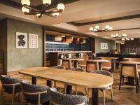 a restaurant with tables and chairs and a bar at Rimrock Banff, Emblems Collection in Banff