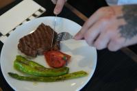 una persona che mangia carne e verdure su un piatto di Kent Room Hotel a Kapaklı