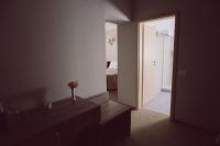 a bathroom with a door leading to a bedroom at C&C Residence Hotel in Bacău