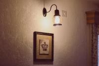 a light and a picture on a wall with a picture at C&C Residence Hotel in Bacău