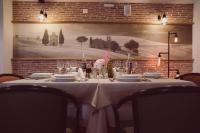 a table with a white table cloth and wine glasses at C&C Residence Hotel in Bacău