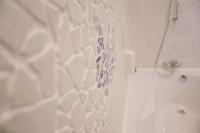 a bathroom with a shower and a tub and a sink at C&C Residence Hotel in Bacău