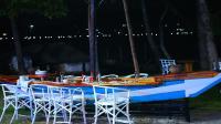 a blue and white table with chairs and a boat at Bayside Resort Lake Victoria- Mbita in Mbita