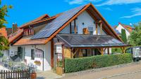 a house with solar panels on the roof at Hotel Fausel in Göppingen