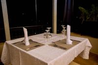 a table with a white table cloth and utensils on it at Velvet Suites in Kigali