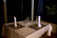 a table with two white candles on top of it at Velvet Suites in Kigali