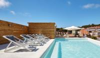 a group of chairs sitting next to a swimming pool at Delamar 4*Sup-Adults only (18+) in Lloret de Mar