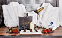 a table with a bottle of champagne and some strawberries at Delamar 4*Sup-Adults only (18+) in Lloret de Mar