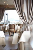 a restaurant with white tables and chairs and a window at Gaia Suites Istanbul in Istanbul