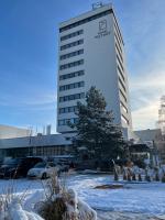a tall building with snow in front of it at Hotel reSTART Superior in Jičín